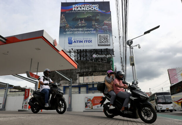 NOT THIS RESUPPLY MISSION Motorists on Tuesday pass by a billboard on Edsa announcing “A Christmas Convoy to BRP Sierra Madre.” The government warns against this civic initiative by the “Atin Ito” coalition to bring relief goods to the grounded vessel and military outpost at Ayungin (Second Thomas) Shoal in the West Philippine Sea. —GRIG C. MONTEGRANDE