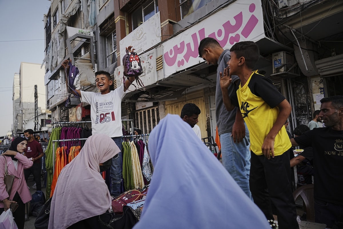PHOTO: Palestinians walk trough a market ahead of the Muslim holiday of Eid al-Adha FOR STORY: Without meat, Gaza families struggle to celebrate Eid al-Adha